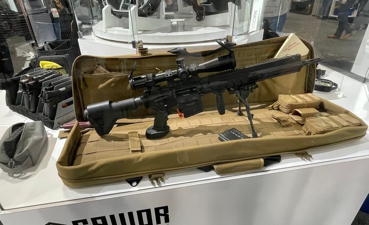 Fuzil exposto em estojo no estande da fabricante Saviour.