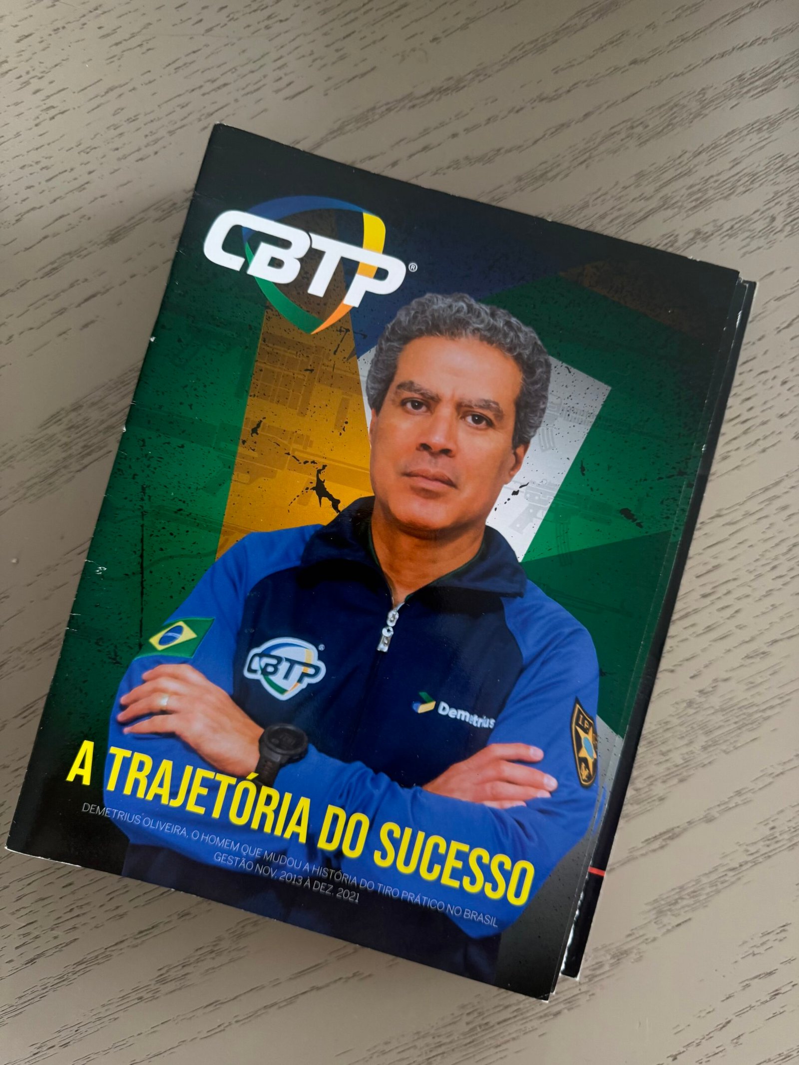 Livro sobre a trajetória de Demetrius Oliveira apoiado sobre uma mesa.