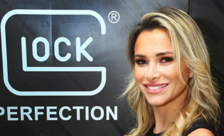 Fabiana Trentin posa diante do logotipo da Glock.